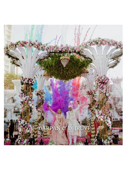 An explosion of color marks the beginning of their forever. This wide shot captures the grand scale of the celebration, with the couple at the center of it all, creating a truly spectacular wedding photograph.