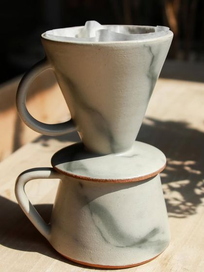 Another shot of the marbled pour-over set, showing the beautiful, subtle swirls of color. It's a one-of-a-kind piece that makes the daily coffee ritual feel special.