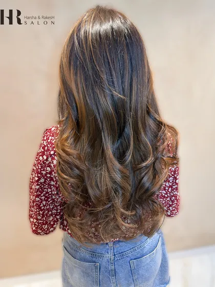 A gorgeous after shot of a balayage service. I added warm, honey-toned highlights to her dark base, creating a beautiful contrast and dimension, finished with classic waves.