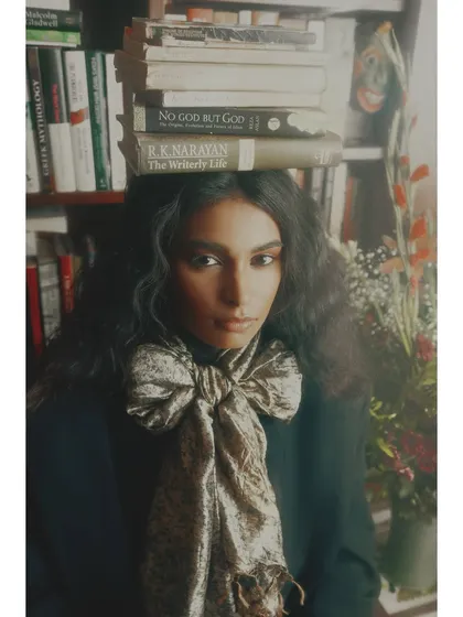 A wider version of the iconic 'Roots' portrait. This shot provides more context of the library setting, reinforcing the theme of knowledge and heritage as foundational to our identity.