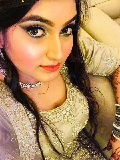 A selfie from a happy client showing off her party makeup. The look includes a classic smokey eye, contoured cheeks, and a nude lip, perfect for a glamorous evening.