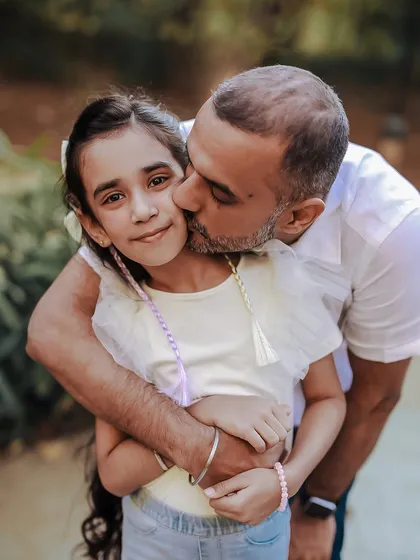 I truly love shooting outdoors. This affectionate moment between a father and his daughter shows how natural light and a beautiful park setting can create stunning, emotional family portraits.