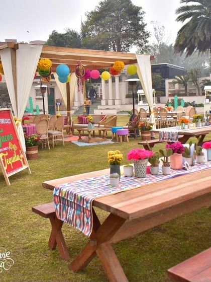 Long picnic tables were decorated with patterned runners and cactus centerpieces, creating a communal and festive dining experience.