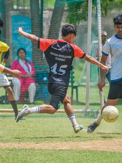 Older athletes compete with intensity during a Pride Cup match, showcasing advanced skills in passing and movement off the ball.