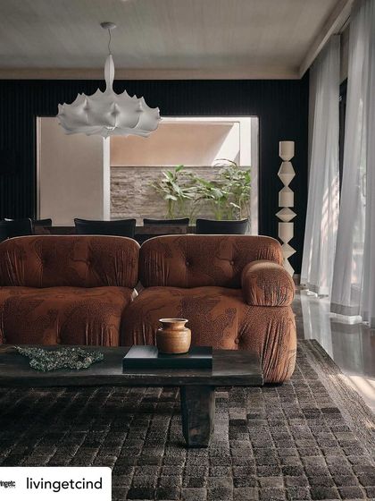 The living room, bathed in natural light, as seen in our Livingetc feature. The design balances dark, moody elements with bright, airy moments.