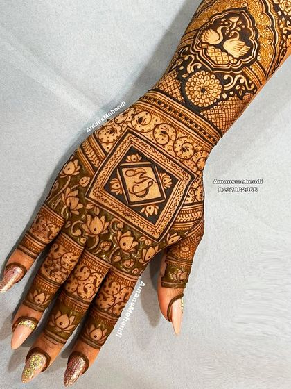 A personalized back-of-hand design with the initials "MS" in a central square. The design is surrounded by intricate floral patterns and features swans on the wrist.