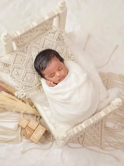 The peaceful, sleepy moments of a newborn are so fleeting. I specialize in creating serene and safe setups, like this cozy macrame bed, to capture your baby's earliest days in a simple, beautiful way.