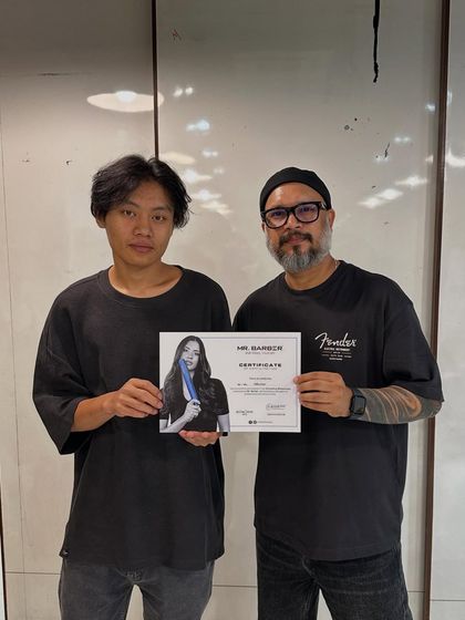 A student poses with his certificate alongside the guest trainer, a moment of achievement and recognition.