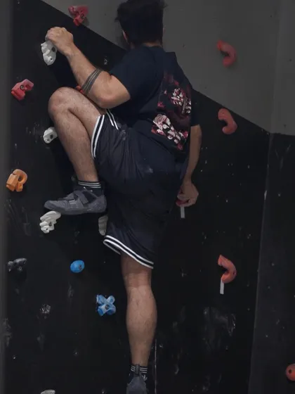 Precision footwork is just as important as upper body strength. This climber carefully places his foot on a small hold to position himself for the next move.
