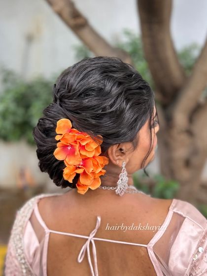 A final look at the elegant textured bun with a bright floral touch.