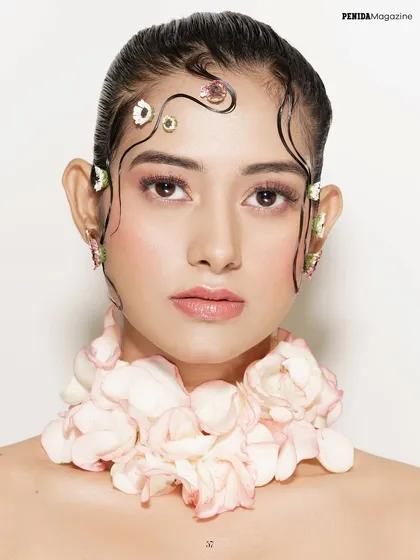 For this Penida Magazine editorial, I used fresh flower petals and delicate, gel-sculpted hair tendrils to create a look of soft, ethereal beauty. The makeup is clean and rosy to complement the floral theme.
