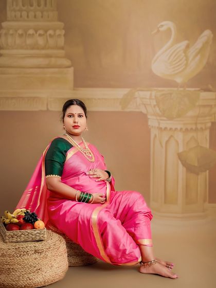 A classic pose with traditional elements like the swan and a basket of fruits, symbolizing fertility and prosperity. This studio setup is designed to honor our cultural heritage.
