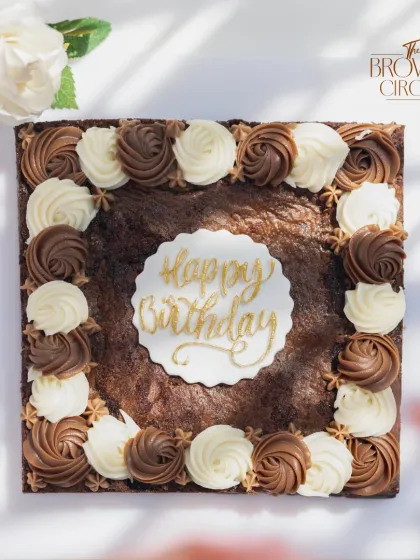 This isn't your average birthday cake. It's my signature fudgy brownie, scaled up for a party and decorated with rich chocolate and vanilla buttercream rosettes. A dream come true for any true chocolate lover's celebration.