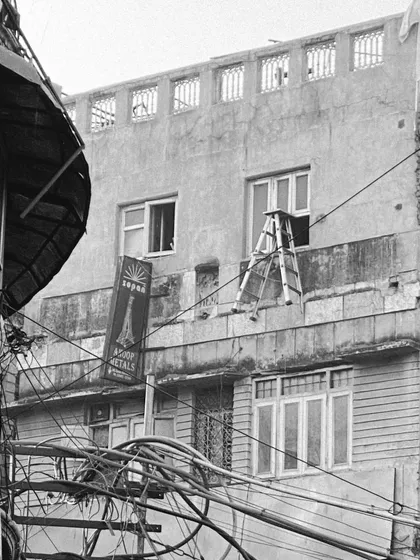 An everyday scene in Old Delhi, captured in black and white. This image reflects the raw, unfiltered beauty of the city's architecture and the lives lived within it.