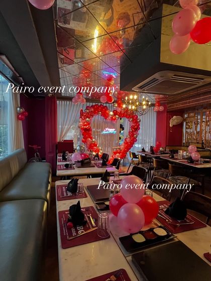 Another perspective of the restaurant anniversary decoration, highlighting the reflections in the ceiling mirrors which add to the festive atmosphere.