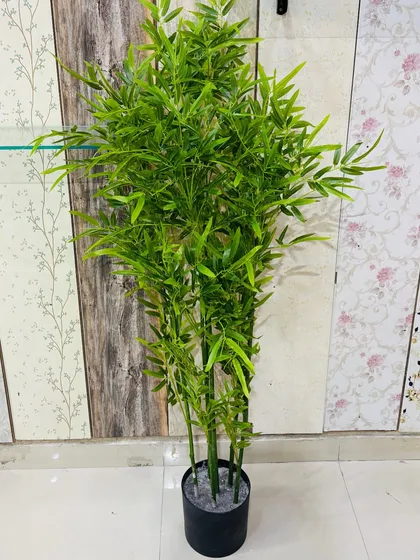 A lush artificial bamboo plant that effectively fills vertical space while maintaining a light and airy feel.