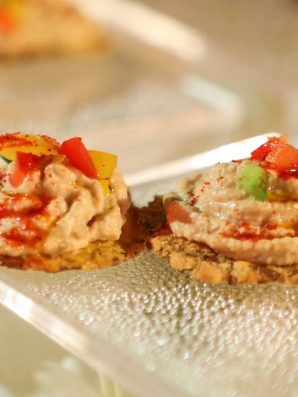 Hummus on a crispy, multigrain cracker. A simple, healthy, and delicious canapé that is always a popular choice.