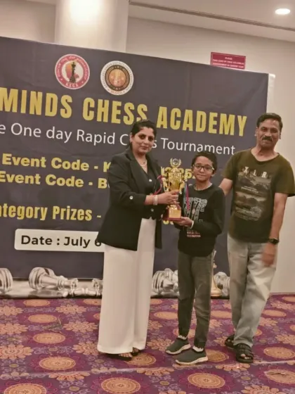 We believe in celebrating every achievement. Here, a proud winner from the Under-9 category receives her trophy at the 1st Brigade Rapid Chess Tournament, a moment she'll cherish.