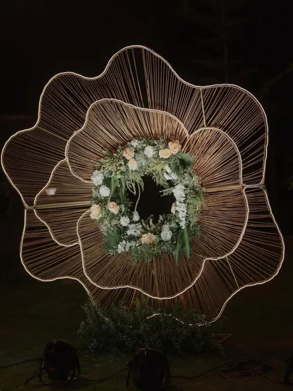 An artistic, large-scale floral light installation. This unique piece serves as a stunning photo-op and a beautiful decor element for an outdoor Sangeet.