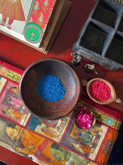 A work-in-progress shot of a runner being created from a scrap of an old, damaged Pichwai painting. This is the ultimate act of renewal, giving a forgotten piece a new purpose.