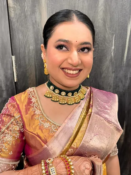 A subtle glam engagement look for this beautiful bride, featuring a sleek bun and defined eyes.