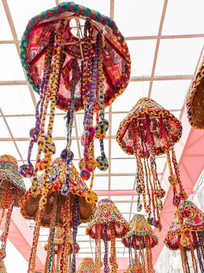 A close-up of the colorful, handcrafted hanging decorations. These intricate details add a layer of artistry and tradition to the event.