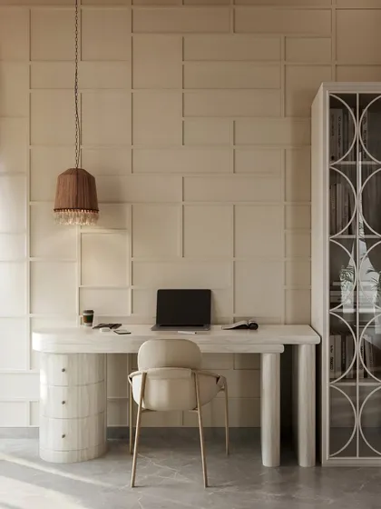 This serene study nook is defined by its textural wall paneling and monochromatic palette. The clean lines of the desk and the elegant, curved legs create a sophisticated workspace that feels both calm and inspiring.