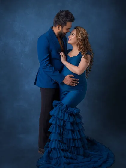 A seated pose that creates a different dynamic, showing the couple's connection and style.