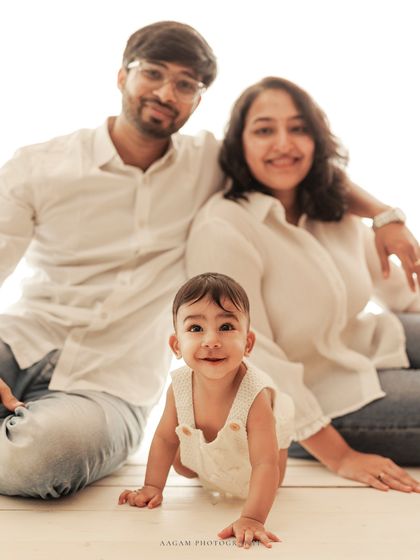 The whole family together, with the baby crawling and smiling. These dynamic shots are full of life.