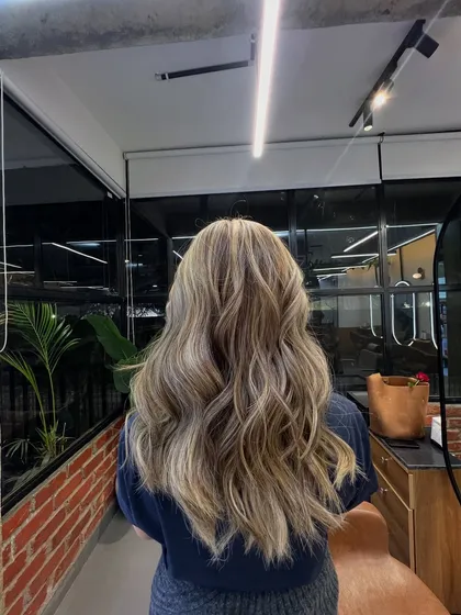 This is the ultimate goal for a lived-in blonde. I used a combination of highlights and lowlights to create this beautiful, natural-looking dimension. The soft waves show off the different tones, resulting in a radiant and healthy-looking finish.