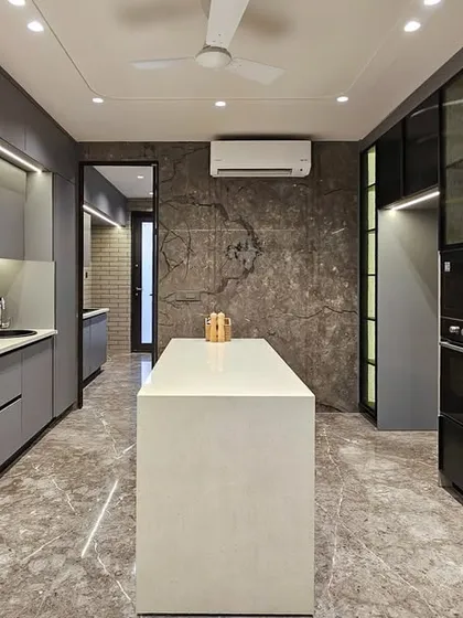A full view of the modern grey kitchen, highlighting its spacious layout and integrated appliances. The design is a perfect balance of minimalist aesthetics and practical, family-friendly functionality.