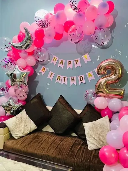 A duplicate of the pink-themed 2nd birthday home decoration, showing the balloon arch, banner, and foil balloons.