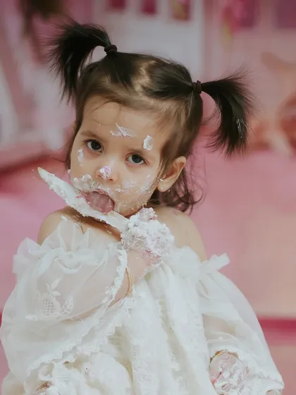 Licking the frosting off a spoon with intense focus. It's these small, funny moments that make for great memories.