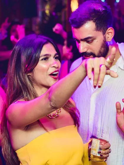 A couple dancing and singing along to a classic track.