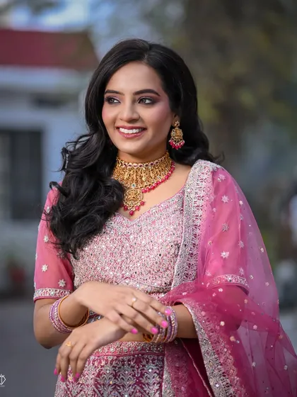 A candid shot of the bride's happy laughter, capturing a moment of pure joy during her engagement festivities.