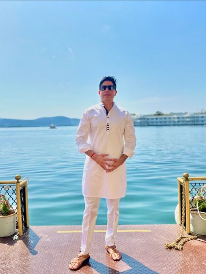 A serene moment on a boat in Udaipur, dressed in a simple white kurta. This shows my connection to the local culture and my ability to adapt my style to any event.