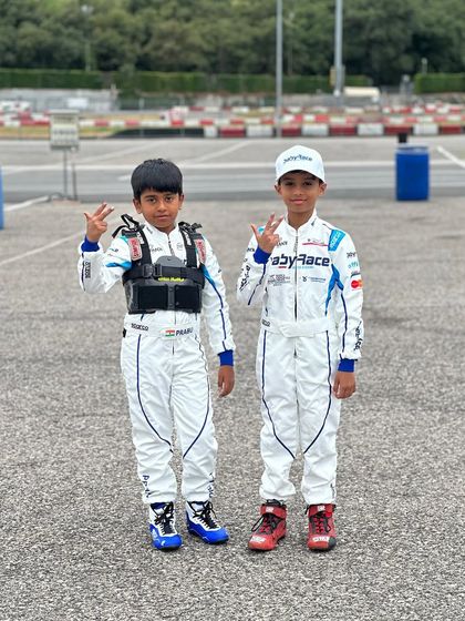 Two of our youngest drivers in their Baby Race Academy suits, ready for their international training camp in Italy.
