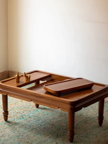 The Mysore Inlay center table is designed for both beauty and function. It includes a removable tray for serving, which, when lifted, reveals the stunning Yakshagana-inspired wood inlay work beneath.