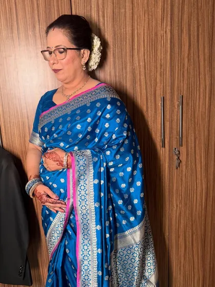 A side view showing her elegant hair bun adorned with a gajra, a classic touch for a traditional look.