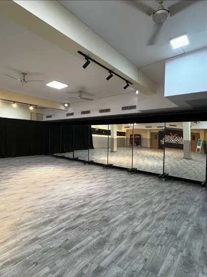 A view of our studio's full wall of mirrors. This essential feature helps dancers refine their technique, check their alignment, and perfect their movements in a professional setting.