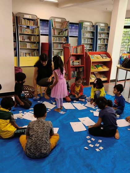 After the story, it's time for hands-on activities. Here, the children are engaged in a fun counting and sorting game.