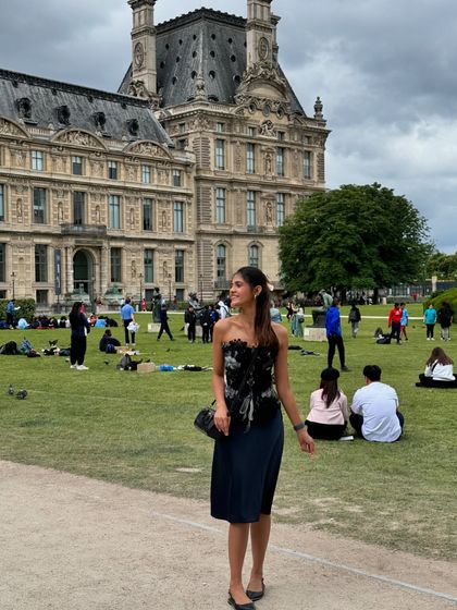 A walk in the Tuileries Garden outside the Louvre. The dark color of the dress provides a nice contrast against the greenery and the classic Parisian architecture.