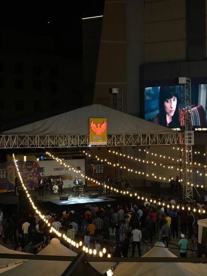 A wide shot of our concert at Phoenix Marketcity, showcasing the large stage, lighting rig, and the enthusiastic crowd gathered in the courtyard.