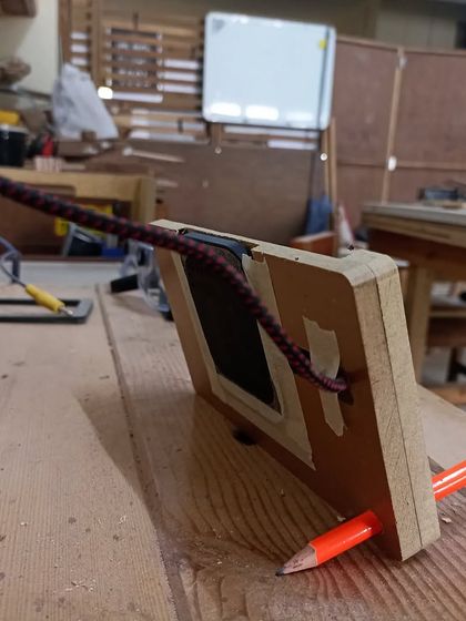 The back of the charging stand, showing the recessed area for the wireless coil and the clever pencil kickstand mechanism.