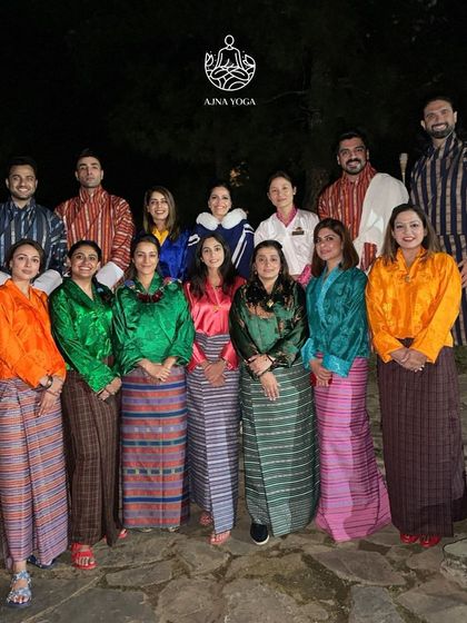 Dressed in traditional Bhutanese attire, our group shares a special evening. Embracing local customs is a beautiful way we connect more deeply with the places we visit.