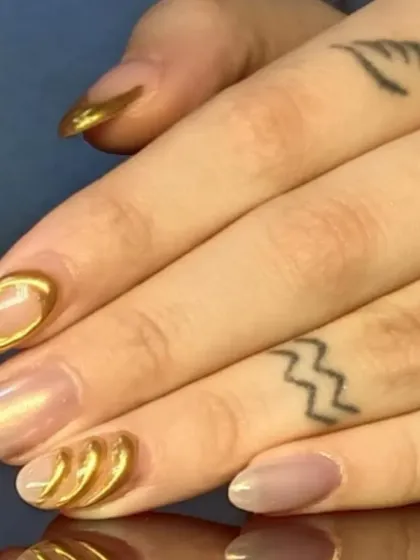 A unique and artistic design featuring 3D sculpted gold chrome accents on a pearlescent base, creating a modern, textured effect.