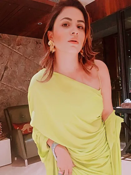 A close-up on the styling of this modern ethnic look, featuring bold gold earrings that complement the vibrant color of the outfit without overwhelming it.