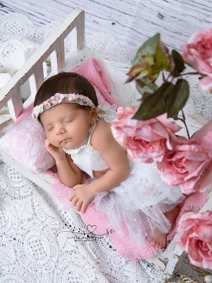 Sleeping beauty on her tiny bed, surrounded by pink roses. This is a classic and beloved setup that always results in a stunning portrait.