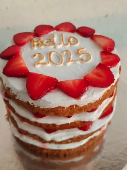 This "Hello 2025" layered cake is made with fresh strawberries and a light sponge. It's a wonderful and tasty way to celebrate the start of a new year.
