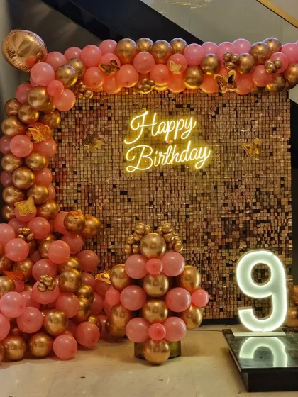 A centered shot of the rose gold sequin wall and balloon arrangement.